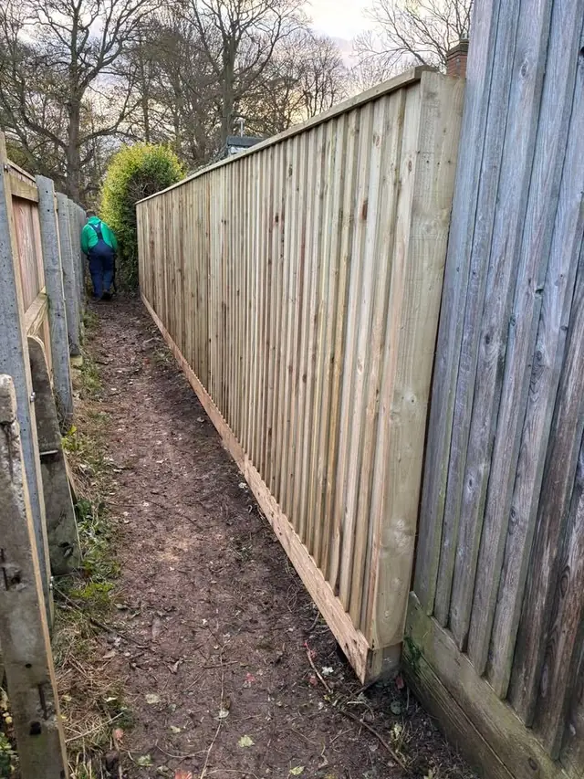 Closeboard fence along a footpath