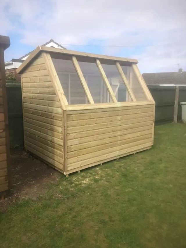 Potting shed with glazed roof panels