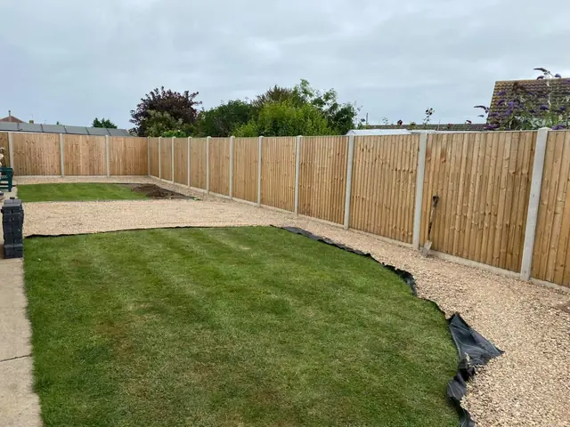 New fencing around a lawn and gravel border
