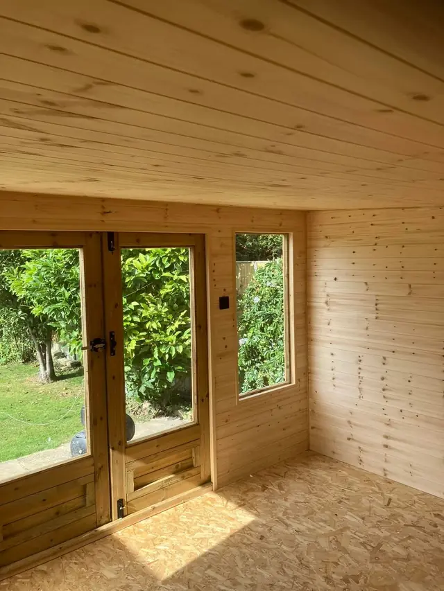 Clad garden room interior with glazed doors