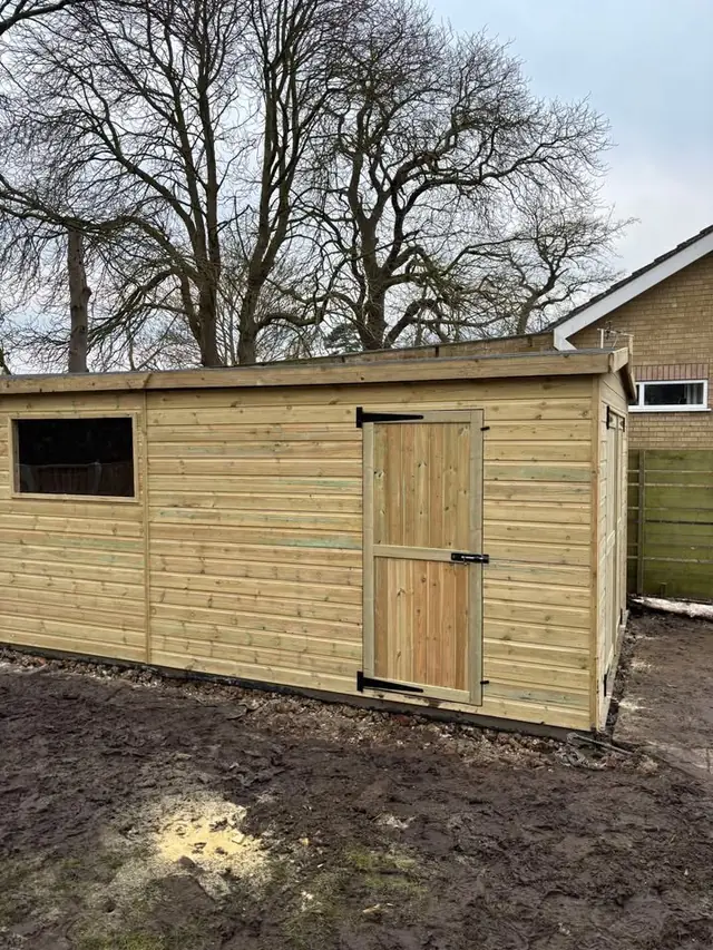 Long pent shed with window