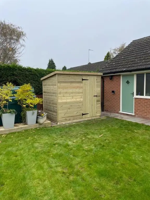 Garden shed next to a house