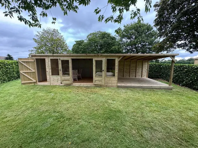 Large garden room with covered veranda and decking